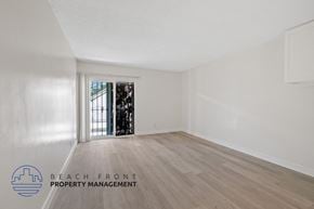 Inglewood apartment for rent - a living room with white walls and wood flooring and a door to a balcony