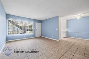 Gardena apartment for rent - A spacious room with a view of a staircase through the window.