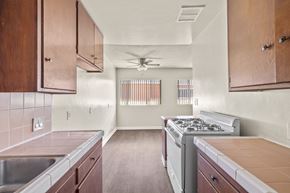 Inglewood apartment for rent - A kitchen with wooden cabinets and a stove top oven.