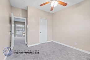 Downey apartment for rent - a bedroom with a ceiling fan and a door to the bathroom