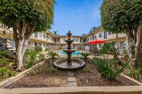 Long Beach apartment for rent - A courtyard with a fountain and trees.