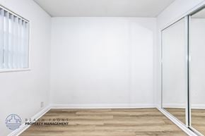 Downey apartment for rent - A room with a sliding glass door and wooden flooring.
