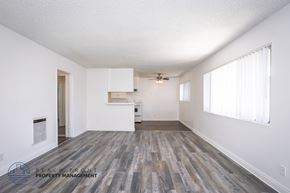 Torrance apartment for rent - A spacious room with wooden flooring and white walls.