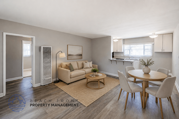 Long Beach apartment for rent - A living room with a dining table and chairs, a couch, and a rug.