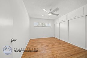 Inglewood apartment for rent - a bedroom with white closets and a ceiling fan