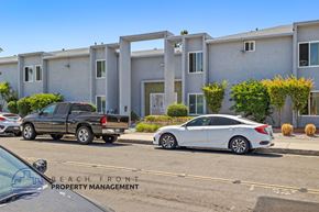 Anaheim apartment for rent - A white car is parked in front of a building with the words