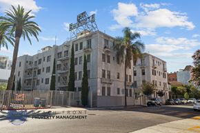 Los Angeles apartment for rent - a building on the corner of a street with palm trees