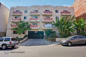 Los Angeles apartment for rent - A building with a sign that says "BEACH FRONT PROPERTY MANAGEMENT" is shown with a car parked in front of it.