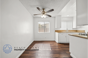 Redondo Beach apartment for rent - a kitchen with white cabinets and a ceiling fan