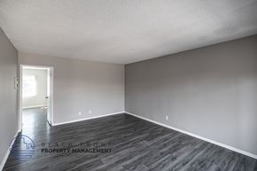 Long Beach apartment for rent - A room with wooden flooring and a logo for Beach Front Property Management.