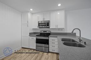 Long Beach apartment for rent - A modern kitchen with a stove, oven, microwave, and sink.