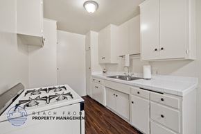 Inglewood apartment for rent - a kitchen with white cabinets and a stove and a sink
