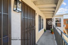 Long Beach apartment for rent - A balcony with a door and a window.