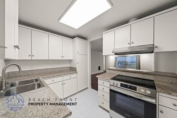 Redondo Beach apartment for rent - A kitchen with a stove, sink, and cabinets.