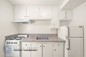 Hawthorne apartment for rent - A kitchen with a stove, sink, and cabinets.