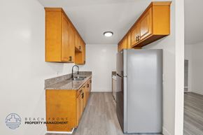 Gardena apartment for rent - A kitchen with wooden cabinets and a granite countertop.