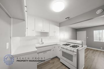 Torrance apartment for rent - A kitchen with white cabinets and a stove top oven.