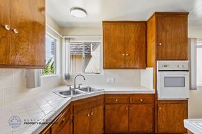 Inglewood apartment for rent - A kitchen with wooden cabinets and a white countertop.