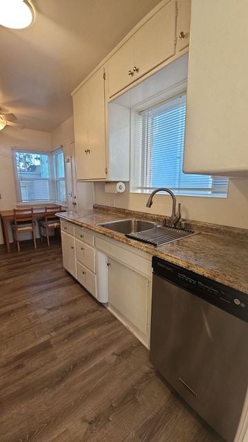 Redondo Beach apartment for rent - A kitchen with a stainless steel dishwasher and wooden floors.