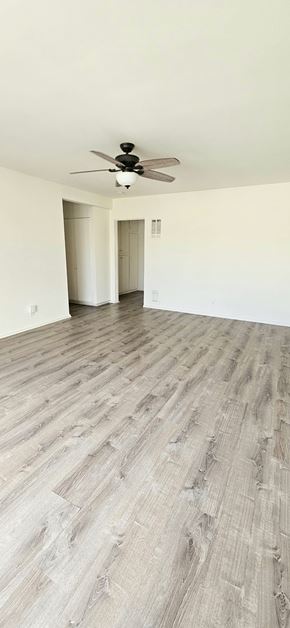 Redondo Beach apartment for rent - A room with a ceiling fan and wood flooring.