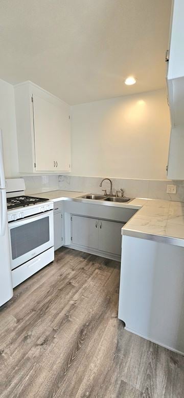 Redondo Beach apartment for rent - A kitchen with white cabinets and a wooden floor.