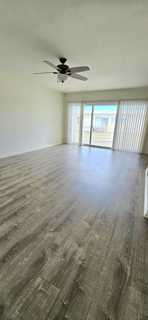 Redondo Beach apartment for rent - A room with a ceiling fan and wooden flooring.
