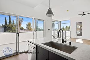 West Hollywood apartment for rent - a kitchen with a large sink and a view of a balcony