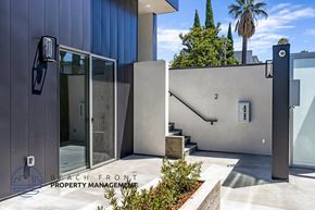 West Hollywood apartment for rent - a modern entrance to a building with stairs and a glass door