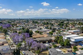 South Gate apartment for rent - A bird's eye view of a residential area with houses, trees, and a clear blue sky.