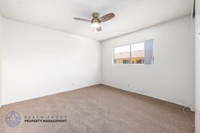South Gate apartment for rent - A room with a ceiling fan and a window.