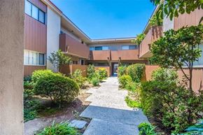 Downey apartment for rent - the courtyard of an apartment building with a walkway and plants