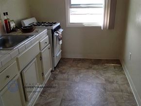 Lennox apartment for rent - a kitchen with a stove and a sink and a window