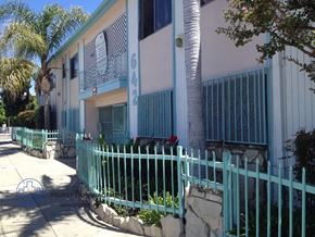 Wilmington apartment for rent - an apartment building with a white fence and a green gate