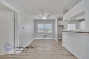 Downey apartment for rent - a kitchen with white cabinets and a ceiling fan