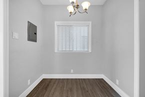 Long Beach apartment for rent - A room with a window and a chandelier.