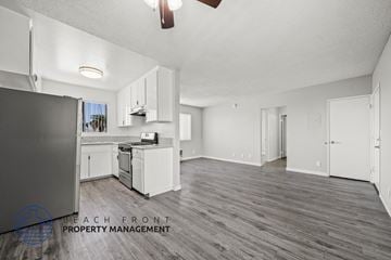 Los Angeles apartment for rent - A spacious kitchen with white cabinets and a wooden floor.