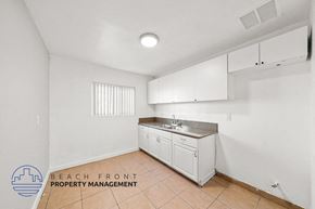 Cudahy apartment for rent - a kitchen with white cabinets and a sink and a counter top