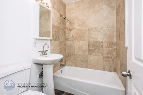 Downey apartment for rent - A bathroom with a white sink and bathtub.
