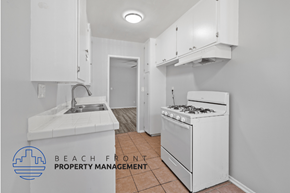 Long Beach apartment for rent - a kitchen with a stove and a sink and a refrigerator