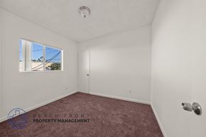 Wilmington apartment for rent - A room with a window showing a view of a building and trees outside.
