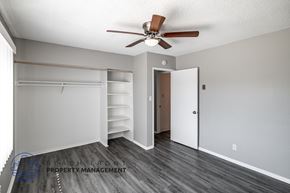 Long Beach apartment for rent - A room with a ceiling fan and a doorway leading to another room.