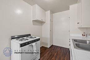 Inglewood apartment for rent - a kitchen with white cabinets and a stove and a sink