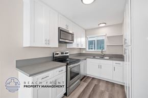 Redondo Beach apartment for rent - A kitchen with white cabinets and a stove top oven.