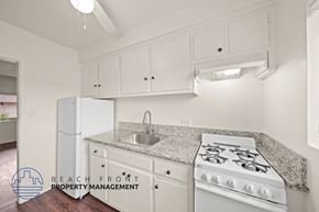 Hawthorne apartment for rent - A kitchen with white appliances and cabinets.