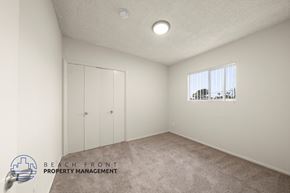 Wilmington apartment for rent - A room with a carpeted floor and a window showing a view of buildings outside.