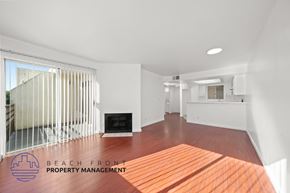 Santa Monica apartment for rent - A spacious living room with a fireplace and a view of the beach.