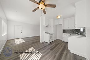 Inglewood apartment for rent - A kitchen with a fan and a logo for Beach Front Property Management.