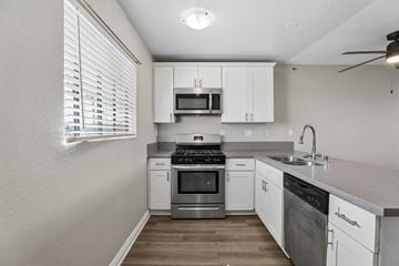 Hawthorne apartment for rent - A kitchen with white cabinets and stainless steel appliances.