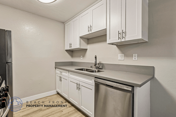 Huntington Beach apartment for rent - A kitchen with white cabinets and a stainless steel dishwasher.