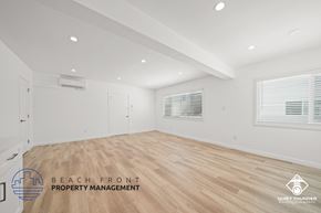 Torrance apartment for rent - a living room with a hardwood floor and white walls and a white door